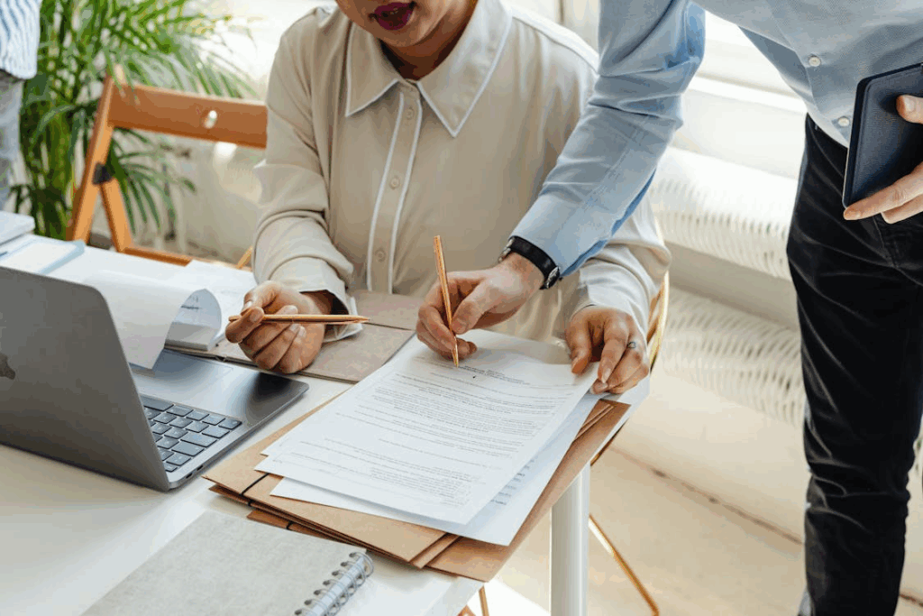 Close up of Woman and Man Working over Papers