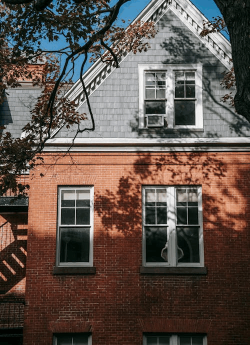Facade of brick residential building against blue sky