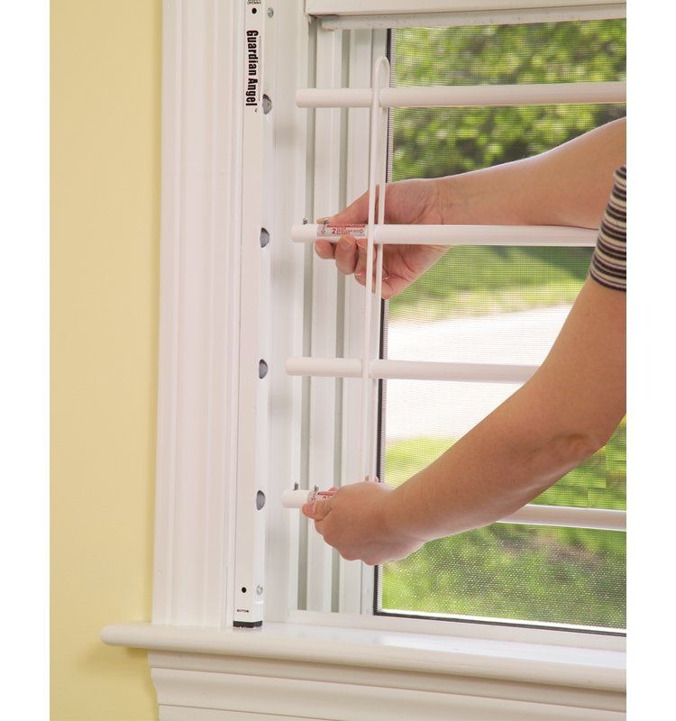 Adjusting white window safety bars, child-proofing a home